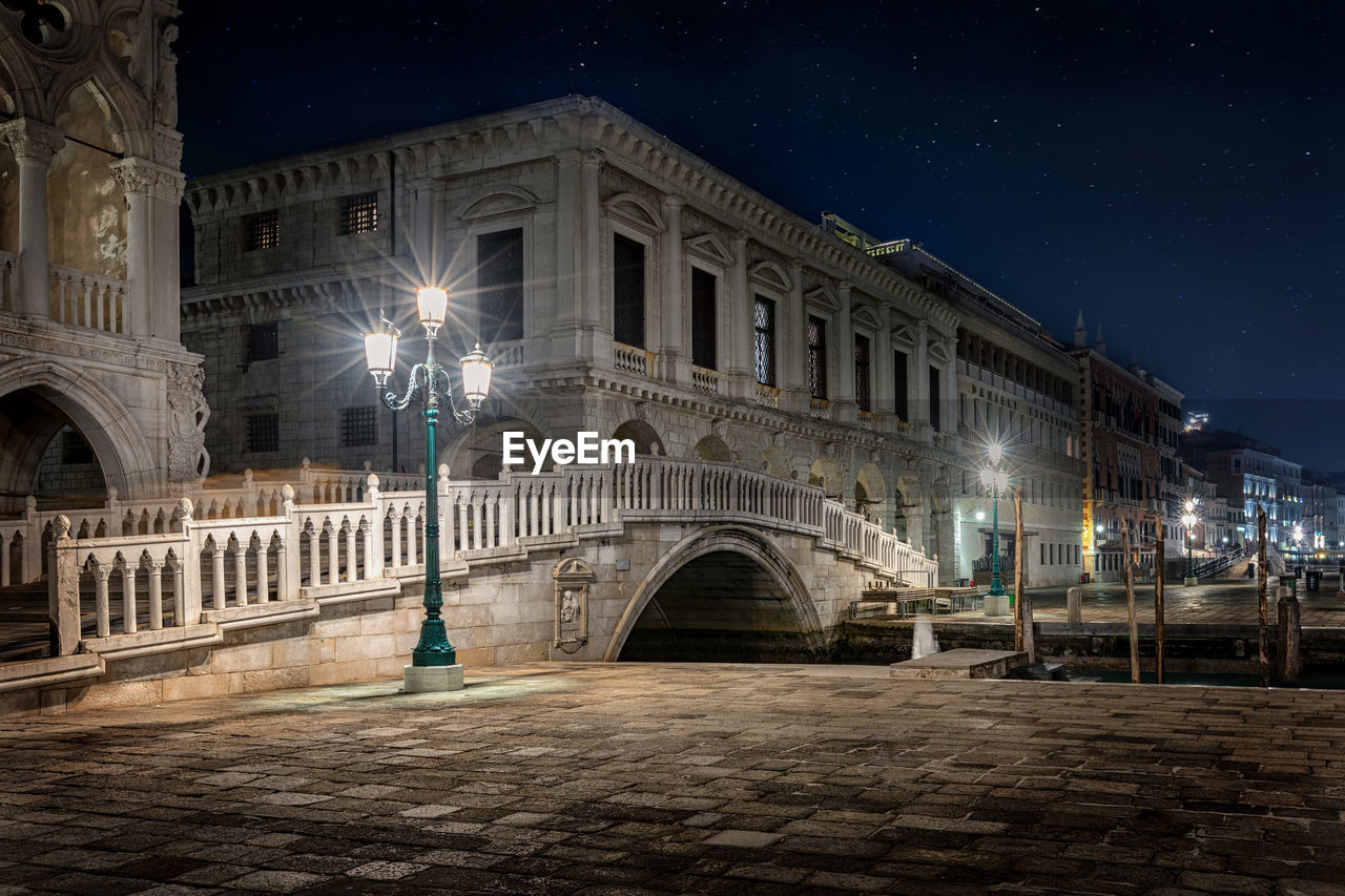 Illuminated street lights and building at night