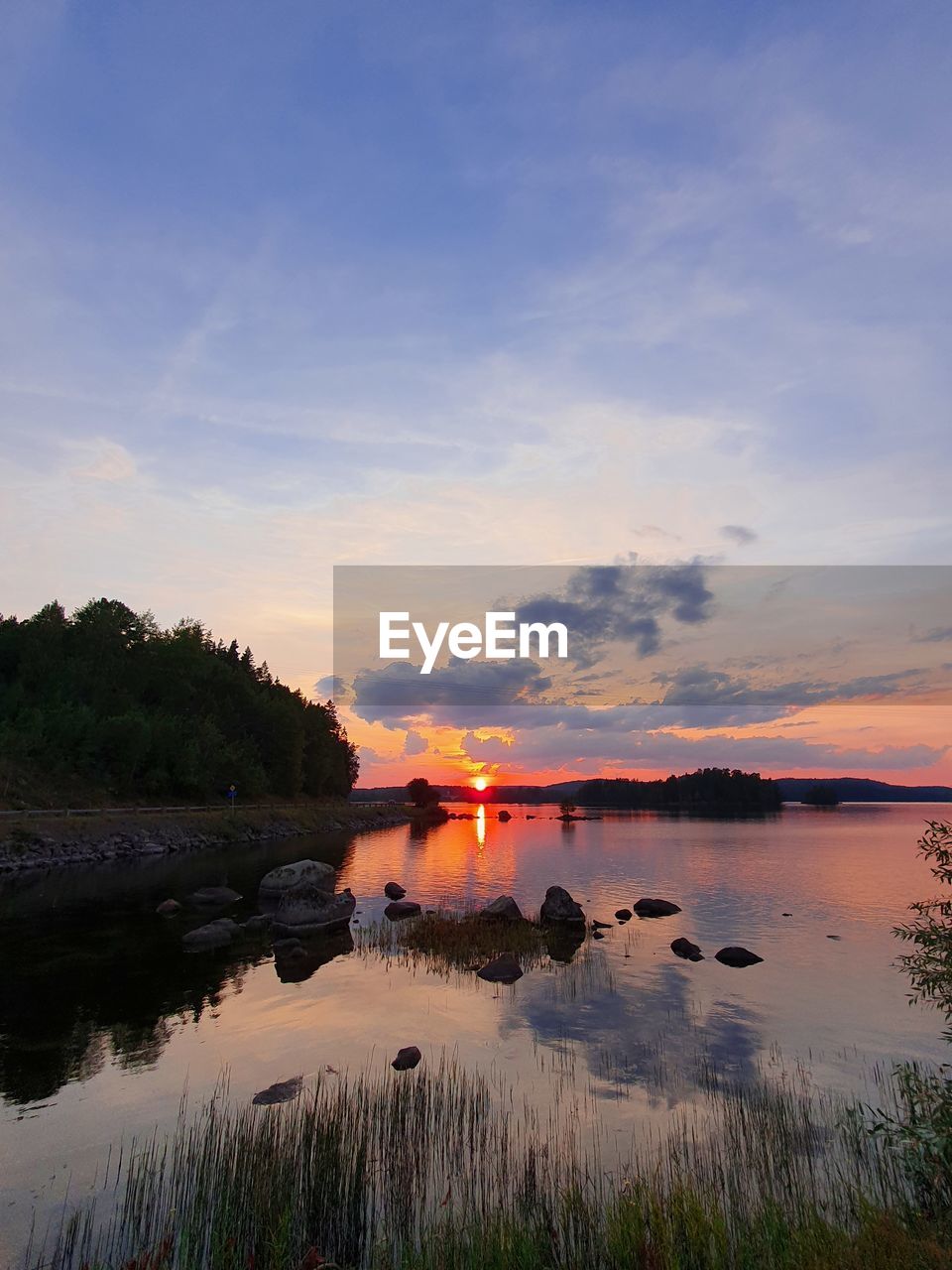 Scenic view of lake against sky during sunset