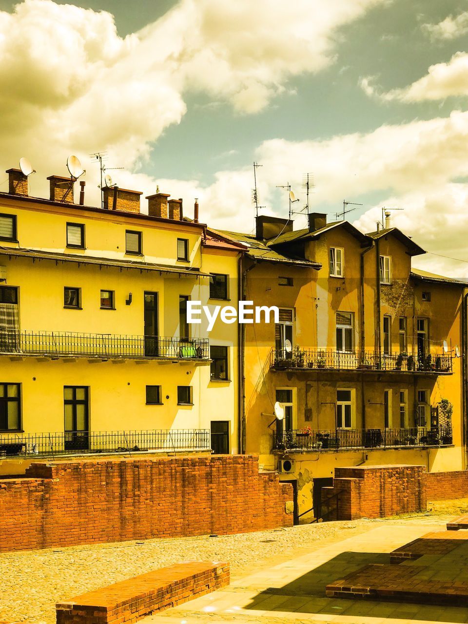 Residential buildings in town against sky