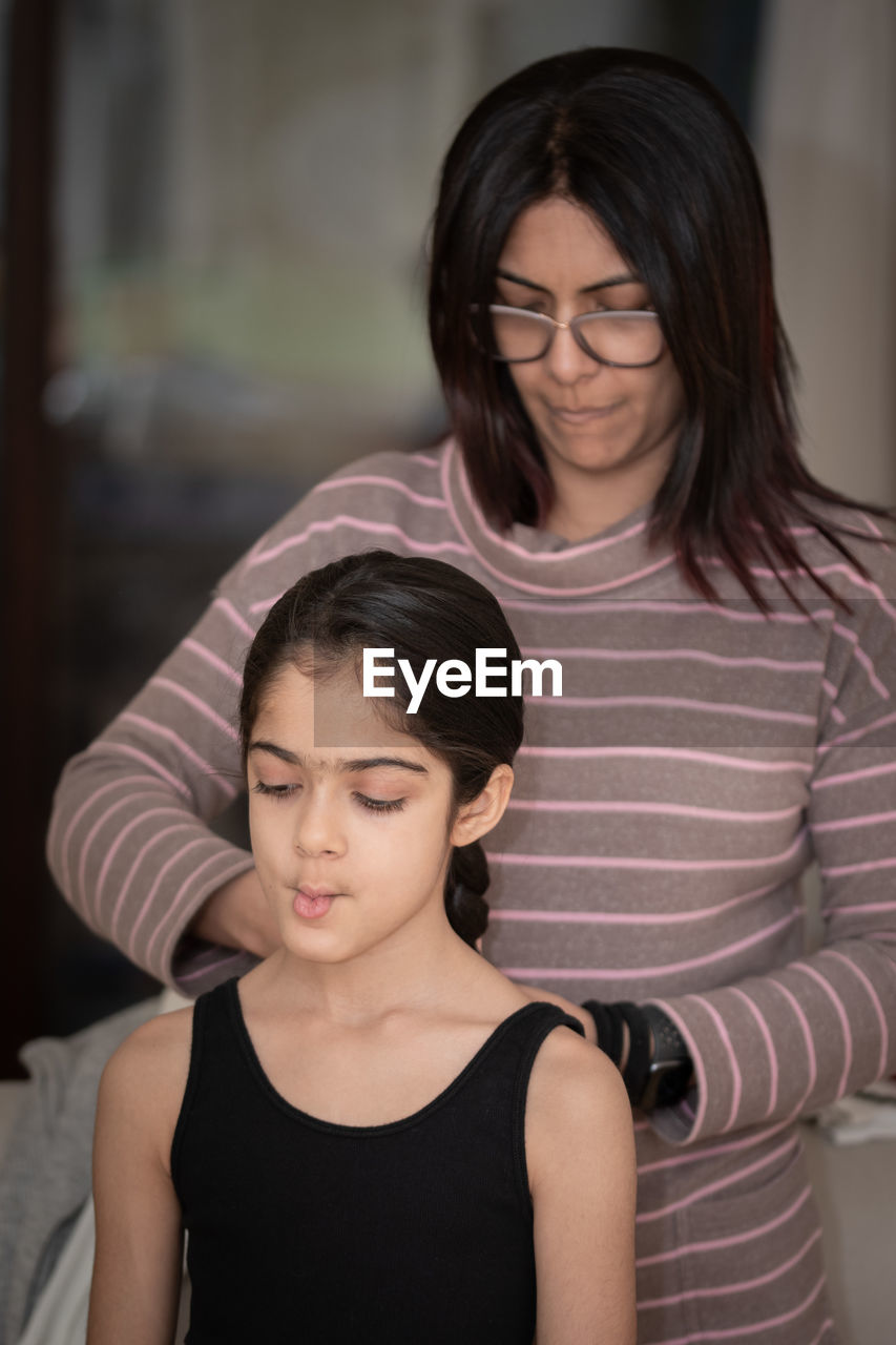 Portrait of young woman getting her hair done.