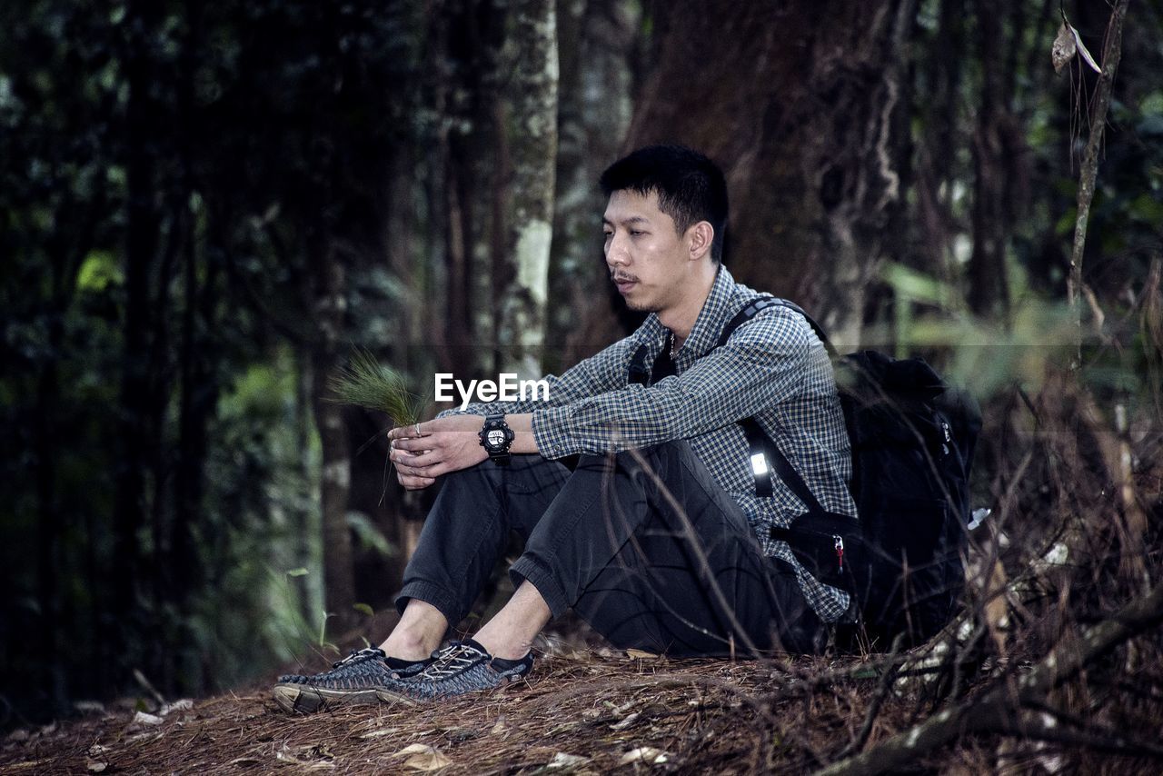 Portrait of young man in forest