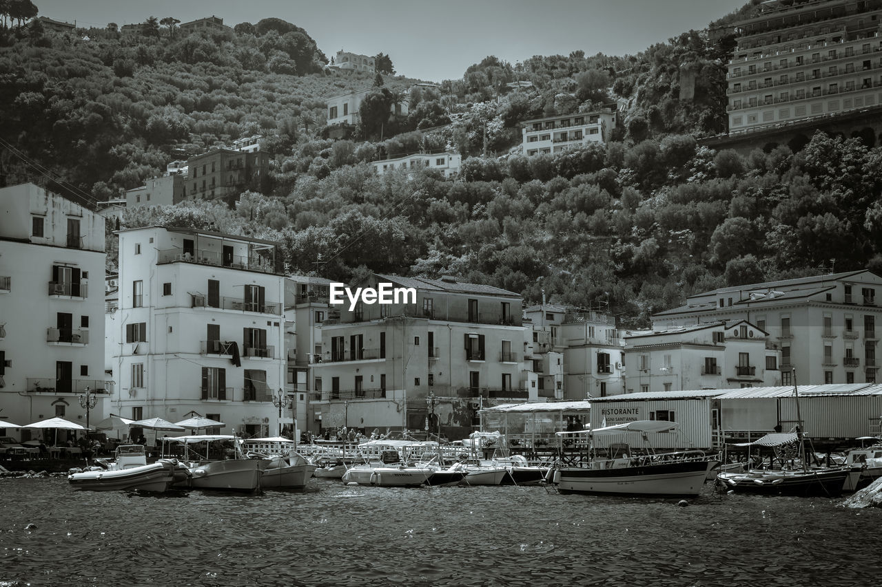 Boats in river with buildings in background