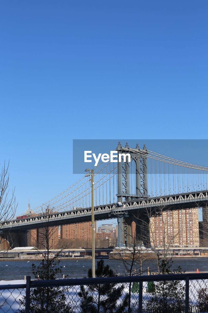 Low angle view of bridge against buildings