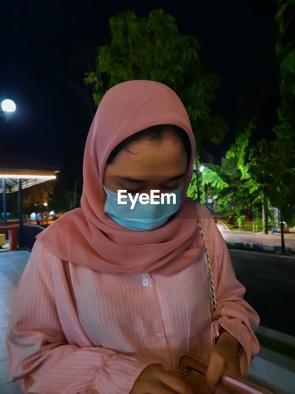 Midsection of woman wearing hat while standing at night. love yourself