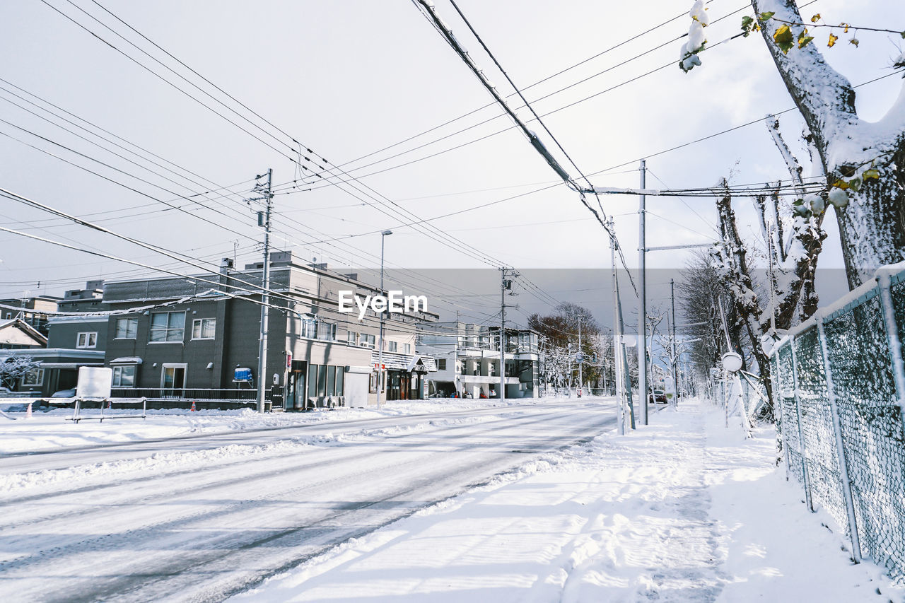 Snow covered road against sky