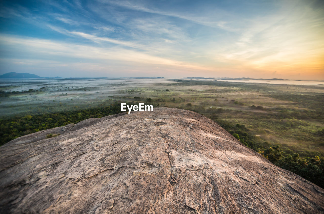 Scenic view of landscape against sky during sunset