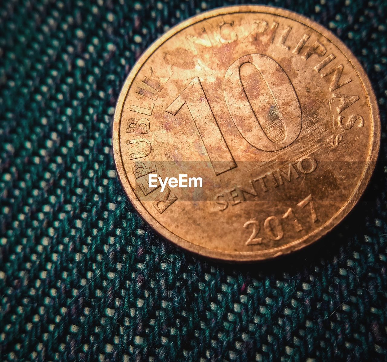 Close-up of coin on fabric