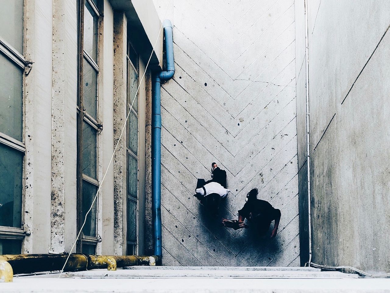 Directly above shot of people walking on alley amidst buildings