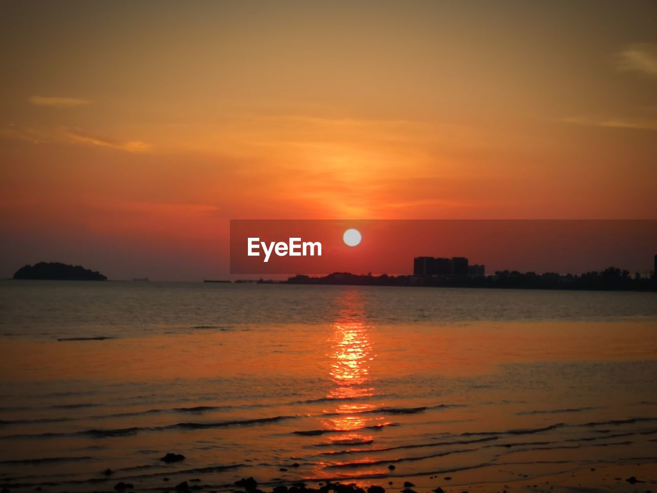 Scenic view of sea against romantic sky at sunset