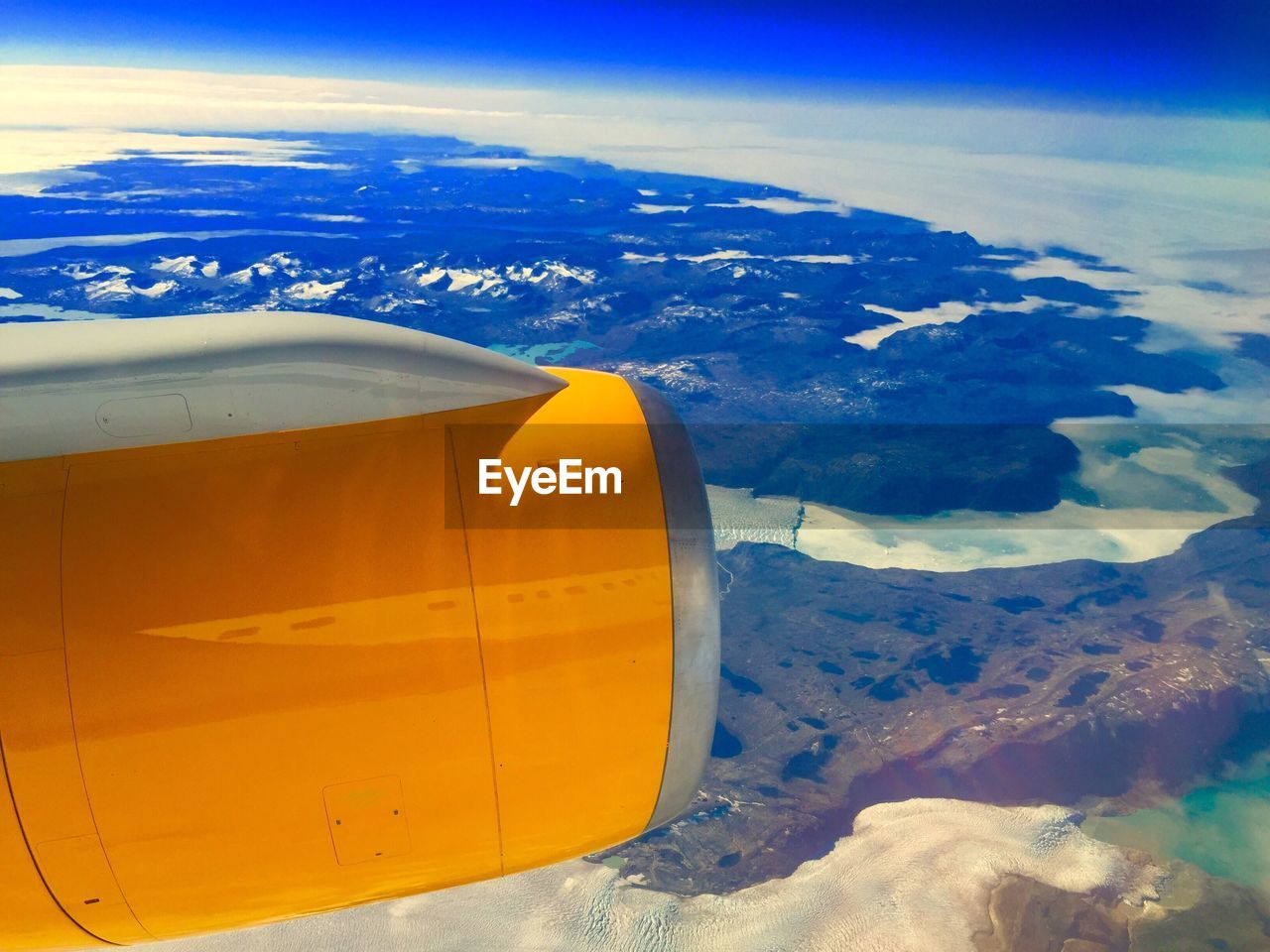 Aerial view of airplane wing over landscape