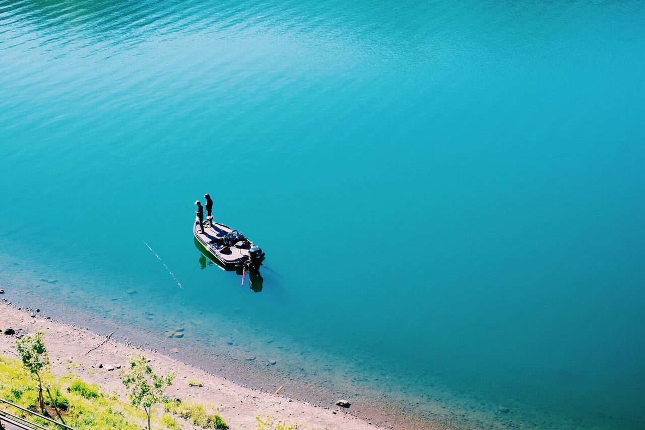 High angle view of people standing on boat at sea