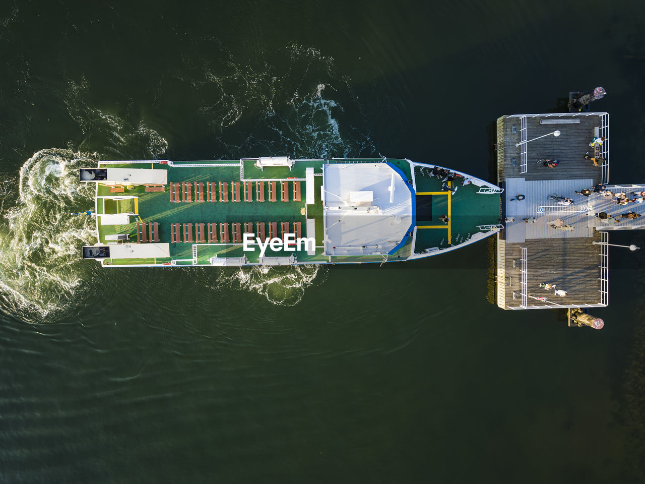 Aerial view of people boarding moored ferry