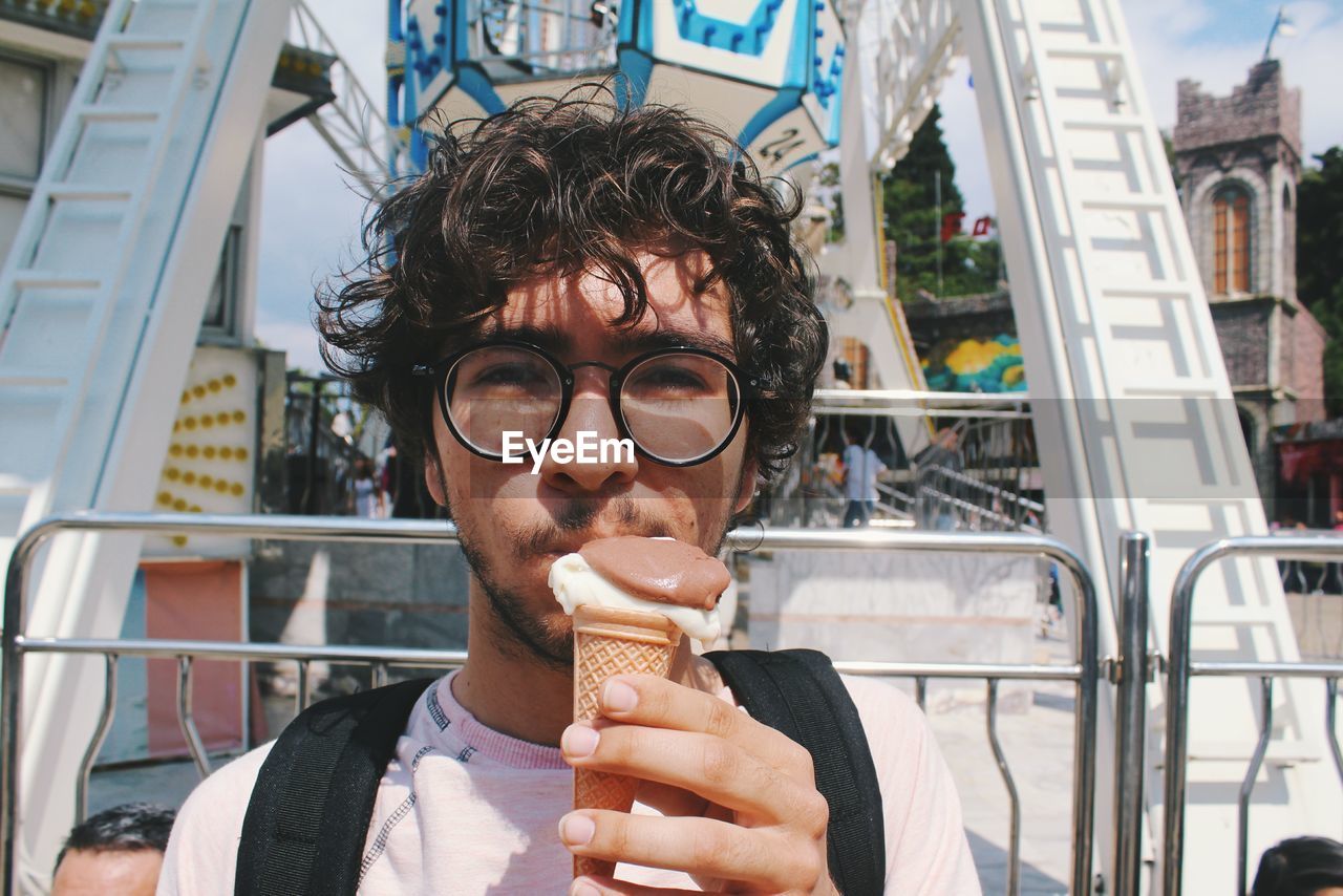 Portrait of young man eating ice cream cone