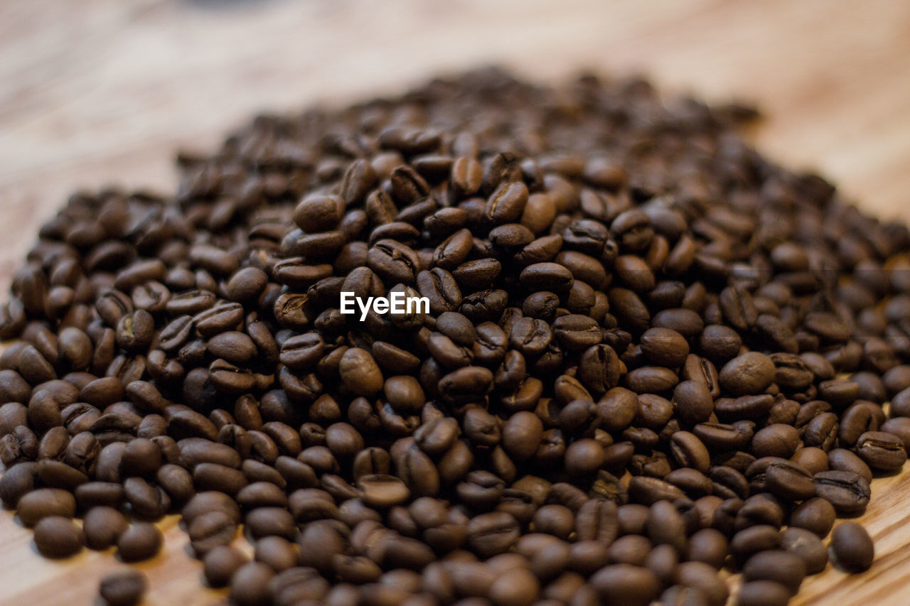 CLOSE-UP OF COFFEE BEANS IN THE BACKGROUND