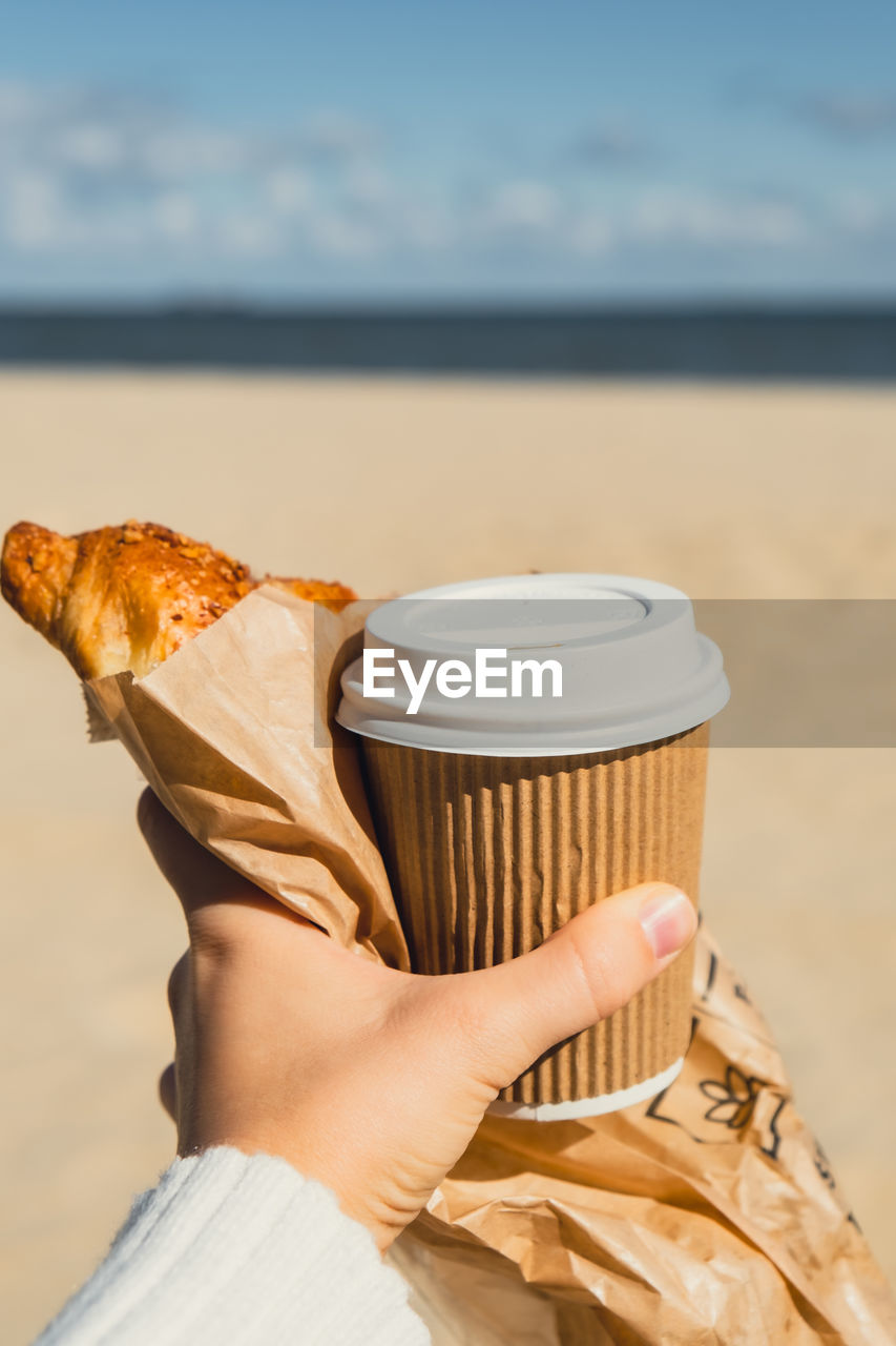 cropped hand of person holding food