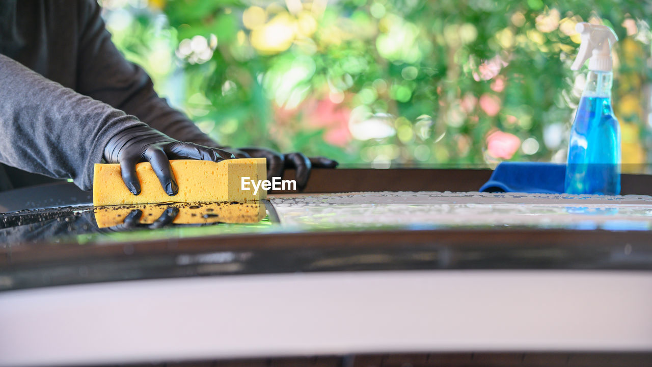MAN WORKING ON TABLE WITH HAND