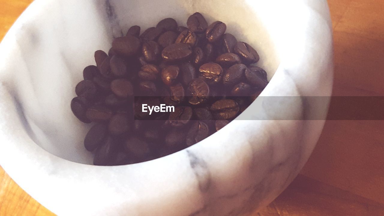 CLOSE-UP OF COFFEE CUP ON TABLE