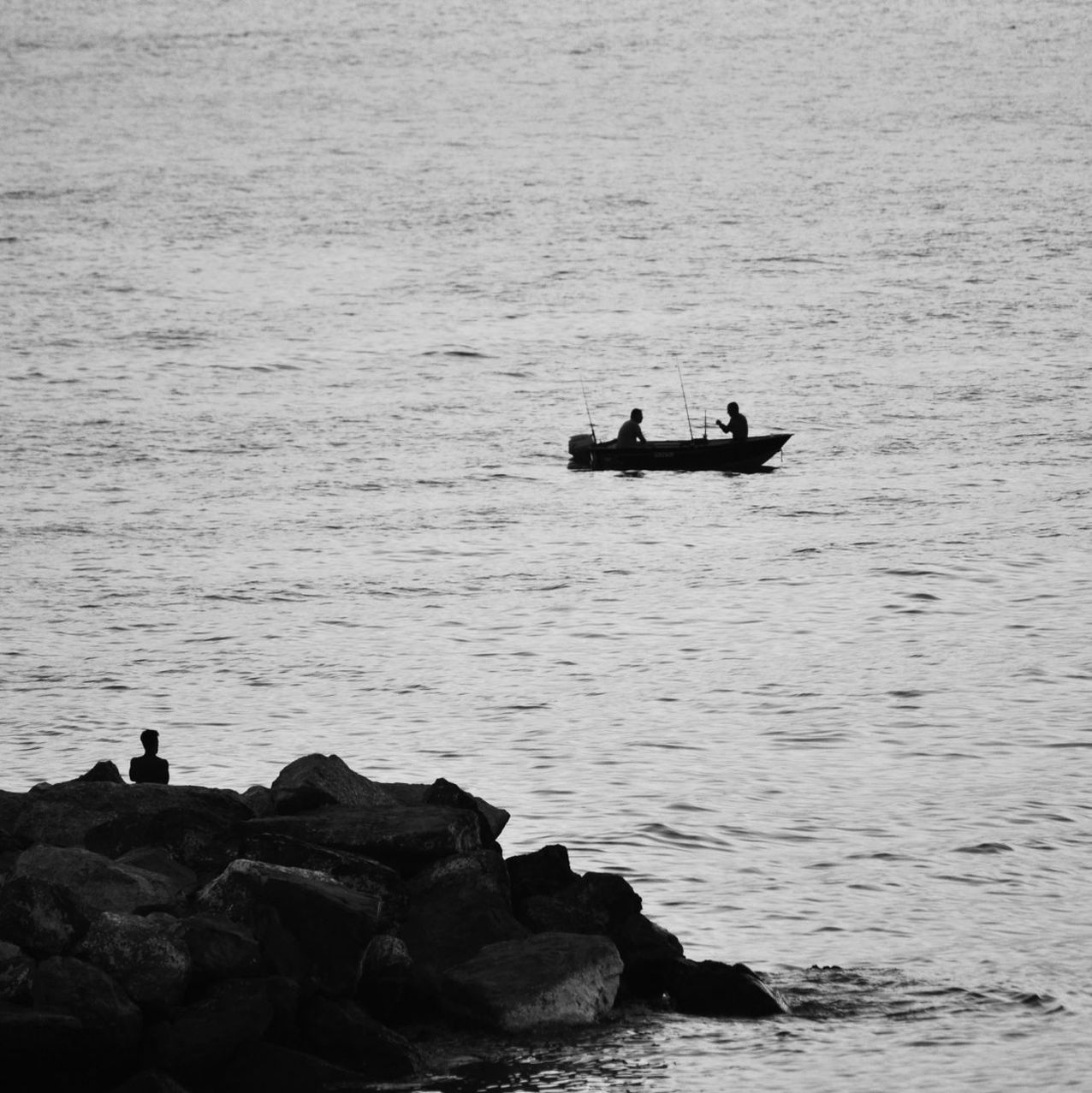 Silhouette of fishermen in boat