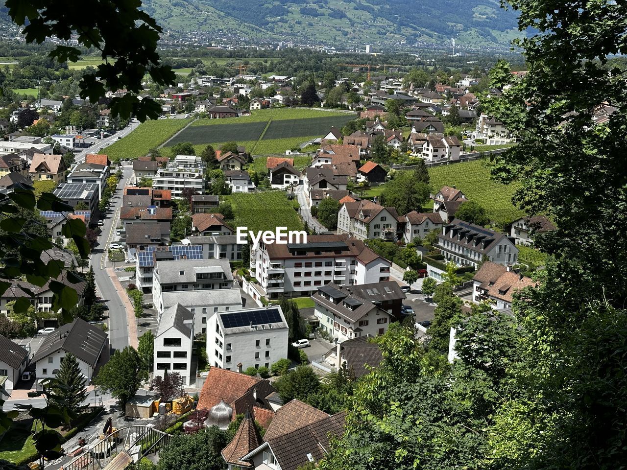 architecture, town, building exterior, built structure, plant, building, residential area, tree, village, high angle view, neighbourhood, aerial photography, residential district, city, suburb, estate, house, nature, bird's-eye view, no people, day, roof, community, outdoors, cityscape, mountain, green, growth, tourism, landscape, environment, mountain range, aerial view, land