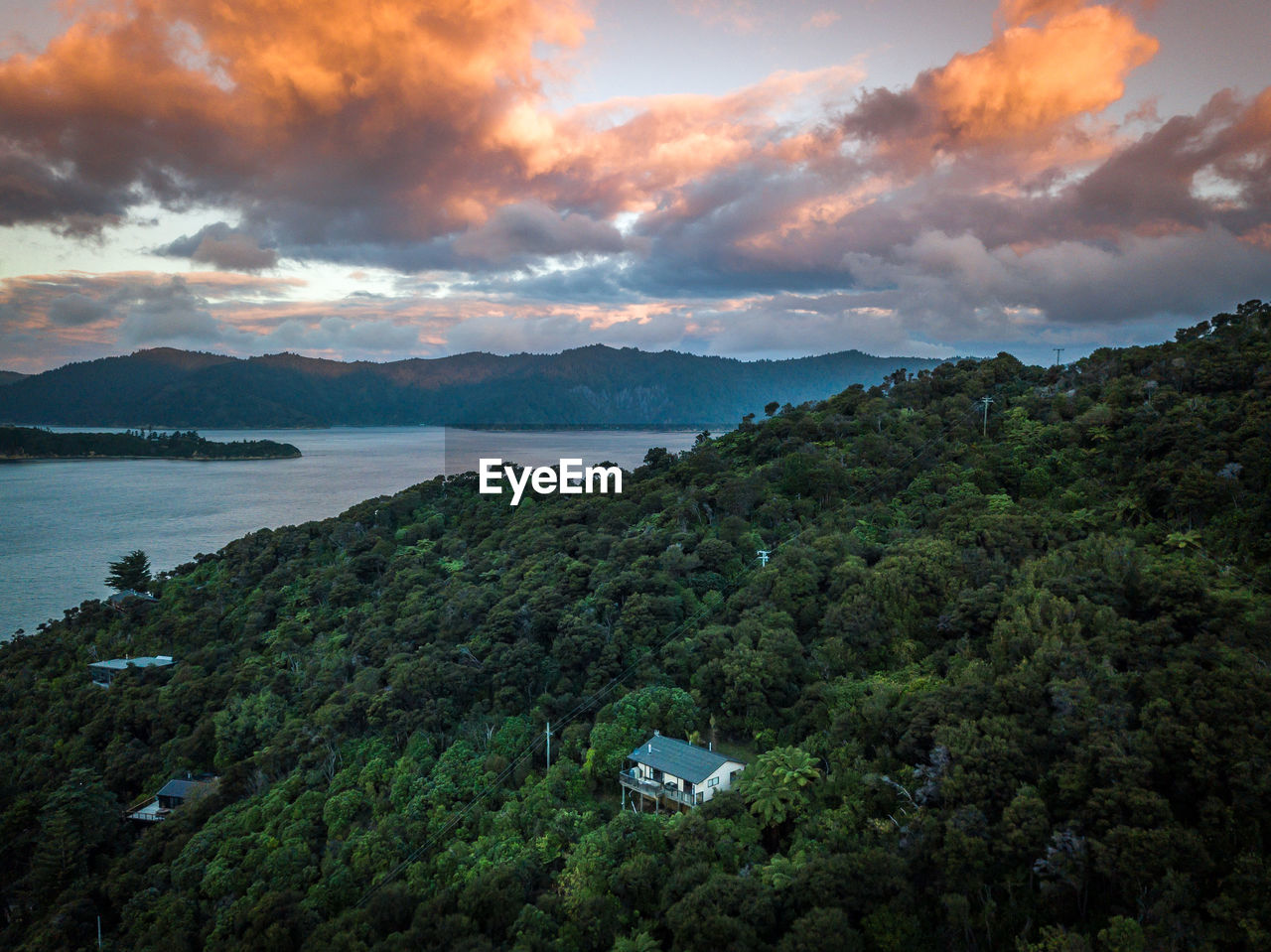 Scenic view of sea and mountains against sky