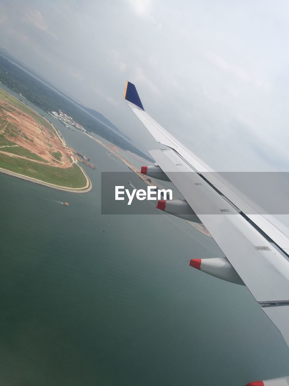 AERIAL VIEW OF AIRPLANE FLYING OVER WATER