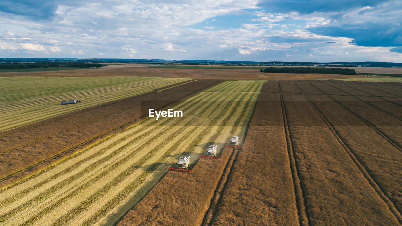 Aerial view of machinery working in agricultural field