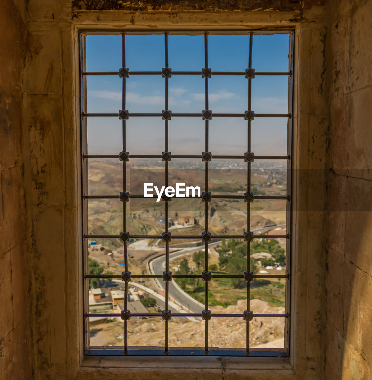 TREES SEEN THROUGH WINDOW OF BUILDING