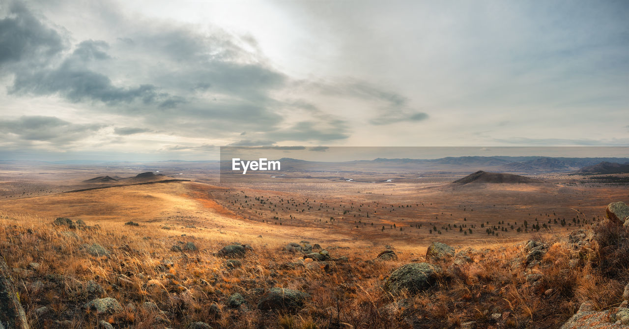 Panoramic view on autumn's steppe from the hill with moody cloudy sky. mekit castle