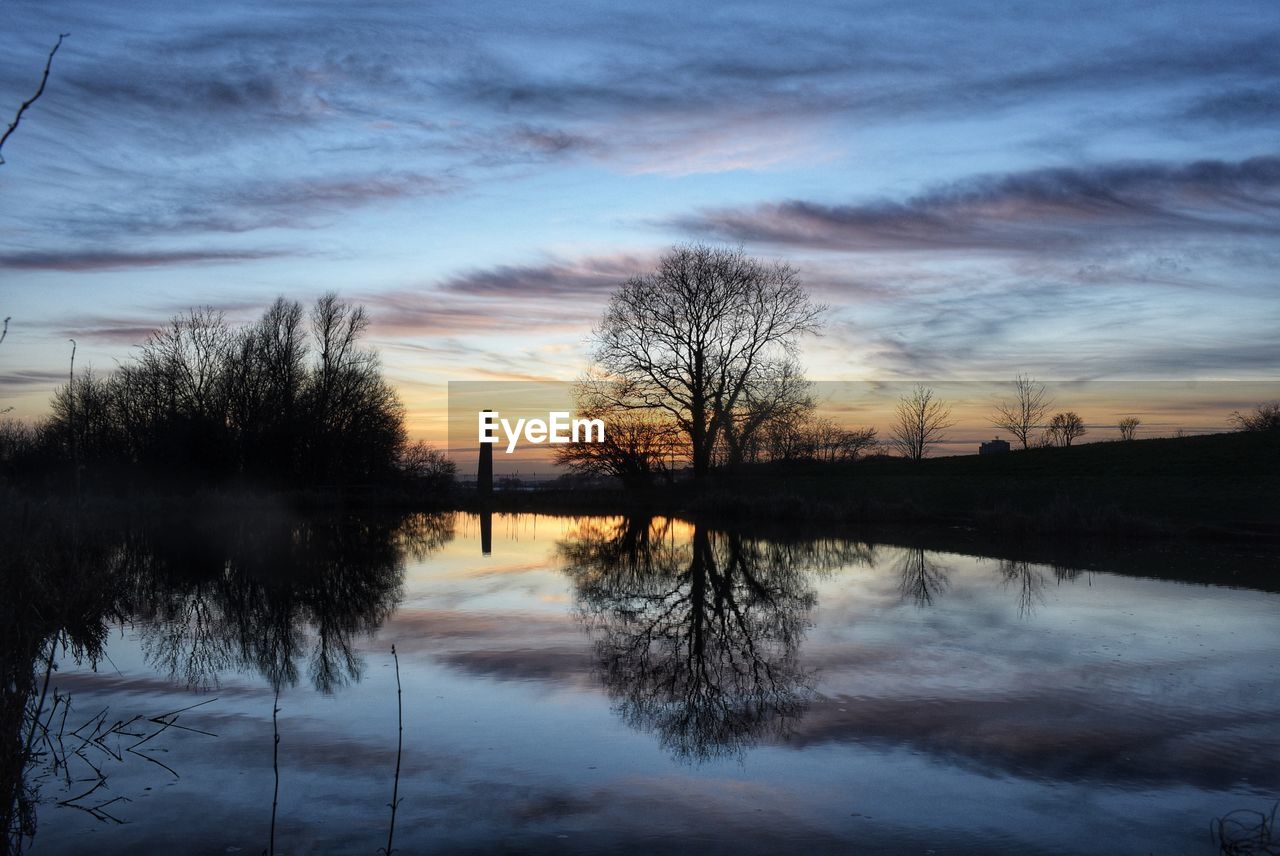 Scenic view of lake against sky during sunset