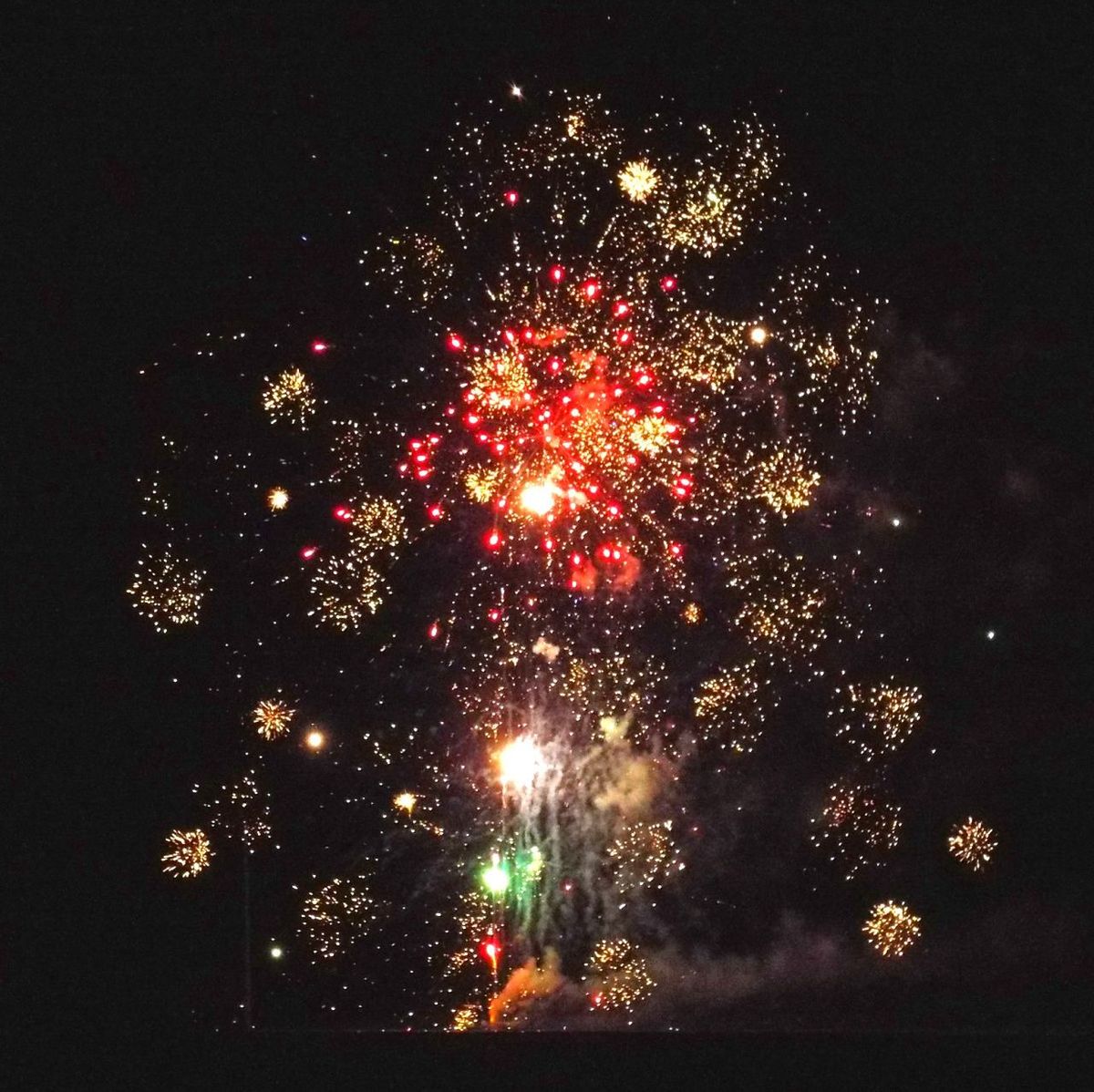 LOW ANGLE VIEW OF FIREWORKS EXPLODING IN SKY