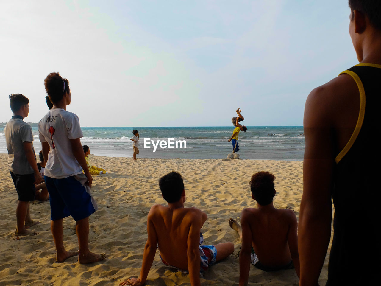 VIEW OF SEA WITH PEOPLE IN BACKGROUND