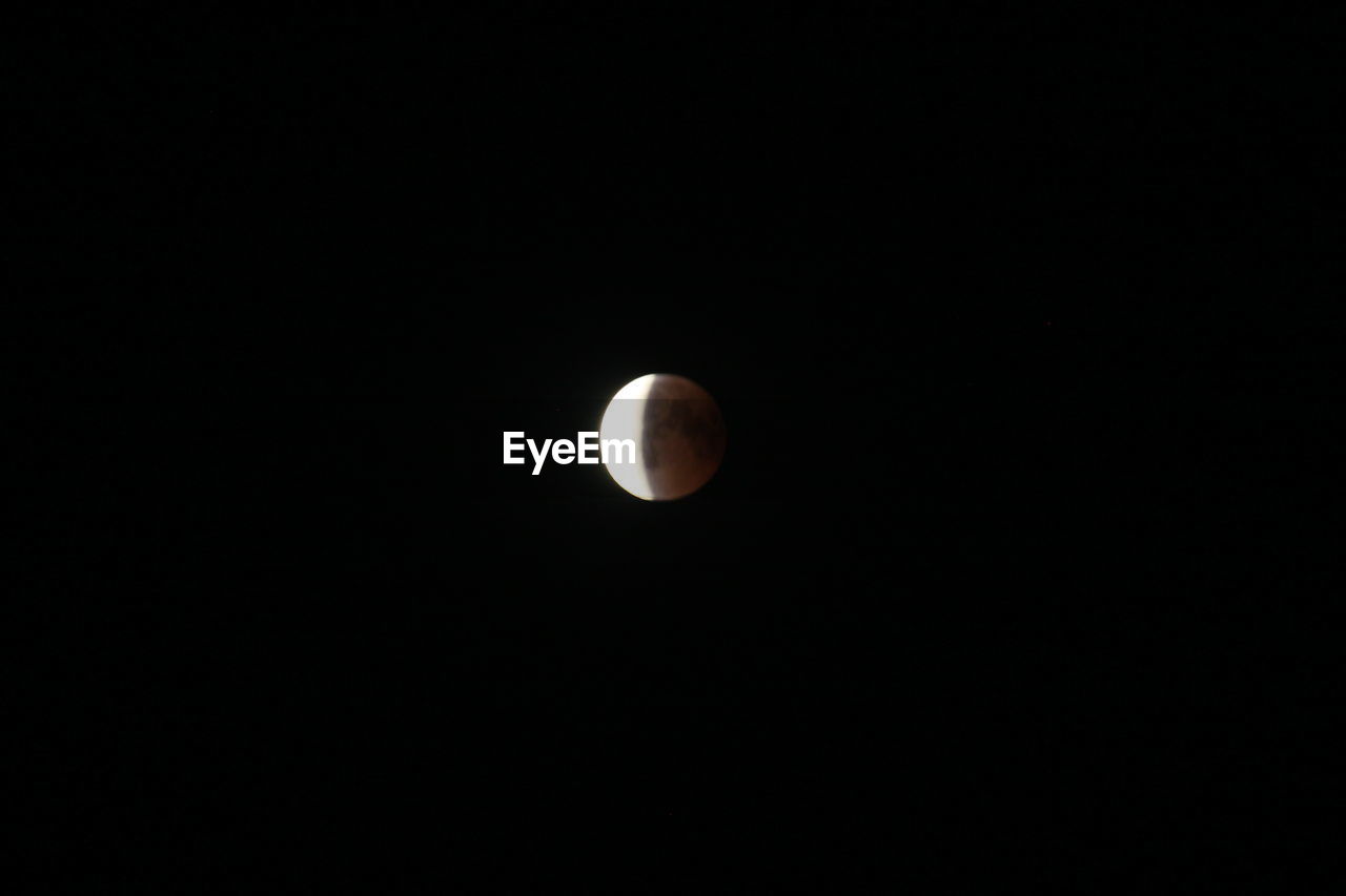 LOW ANGLE VIEW OF MOON AGAINST THE SKY