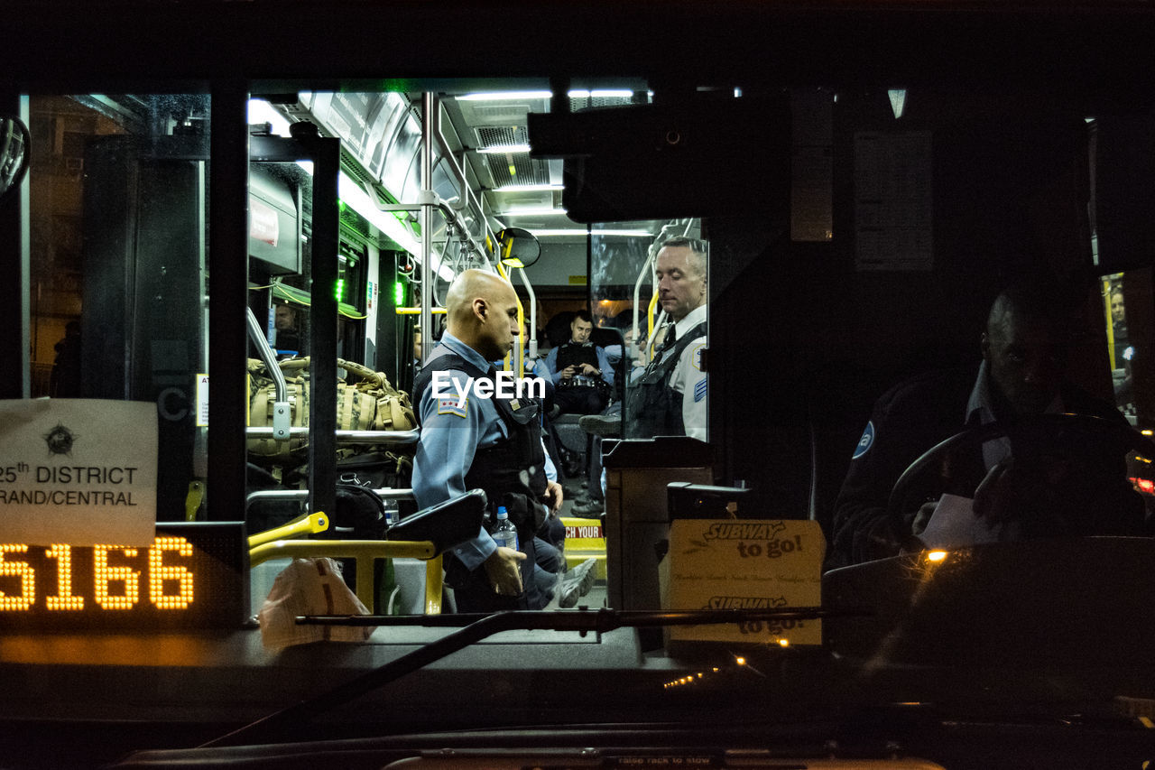 MEN IN ILLUMINATED CITY