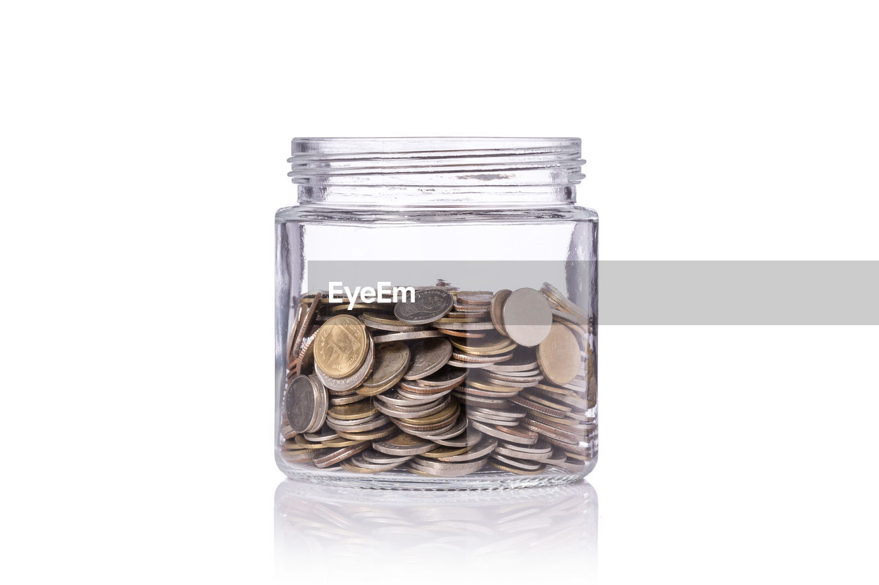 CLOSE-UP OF COINS IN CONTAINER