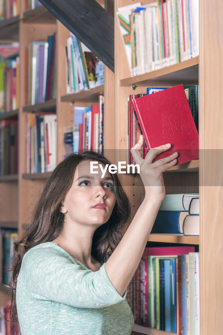 Woman holding in library