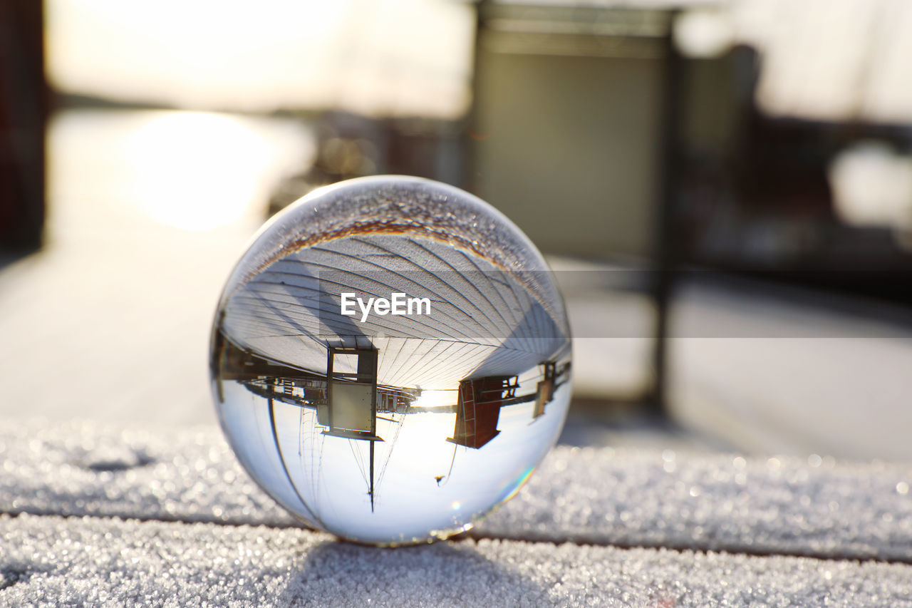 CLOSE-UP OF CRYSTAL BALL ON GLASS