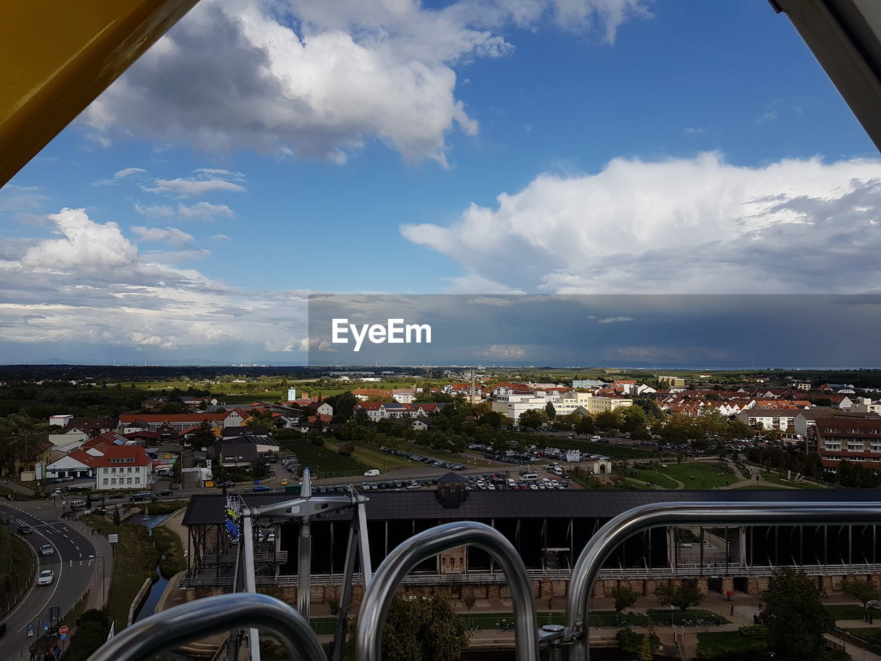 HIGH ANGLE VIEW OF BRIDGE AND BUILDINGS AGAINST SKY