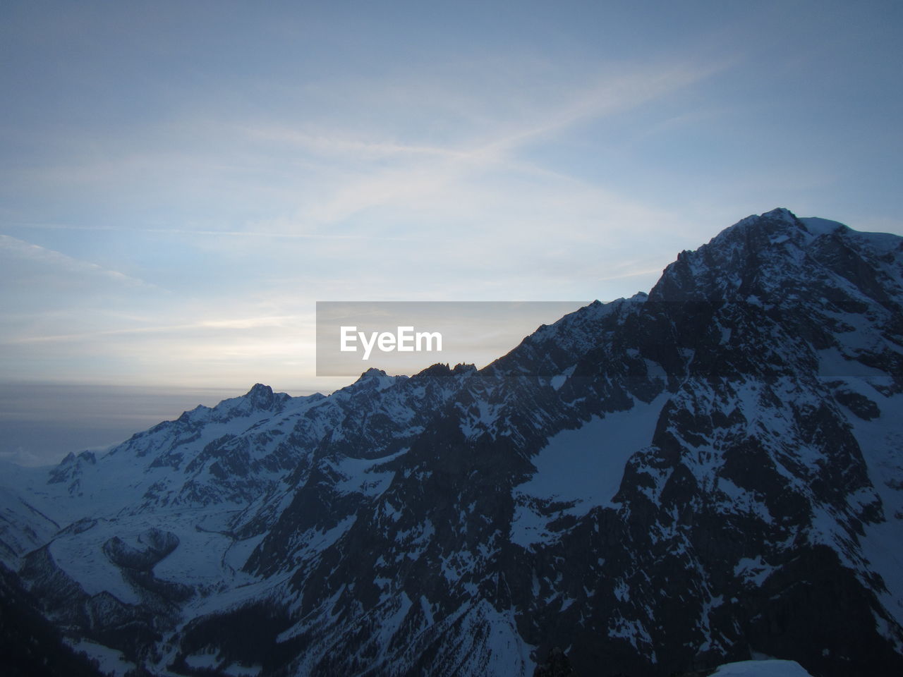 SCENIC VIEW OF SNOWCAPPED MOUNTAIN AGAINST SKY DURING WINTER