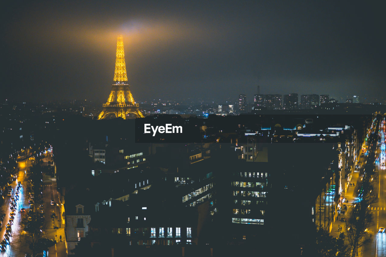 ILLUMINATED BUILDINGS IN CITY AGAINST SKY AT NIGHT