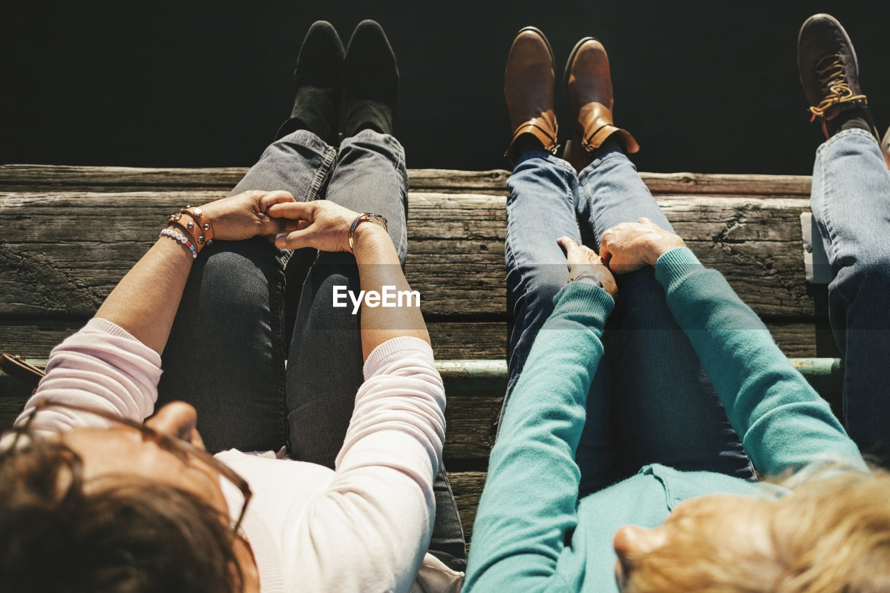 High angle view of senior women sitting on pier