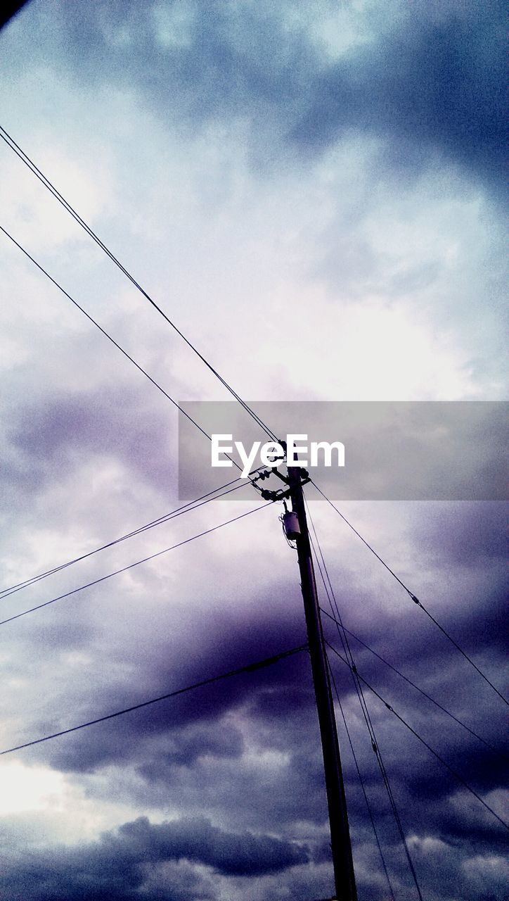 LOW ANGLE VIEW OF POWER LINES AGAINST CLOUDY SKY