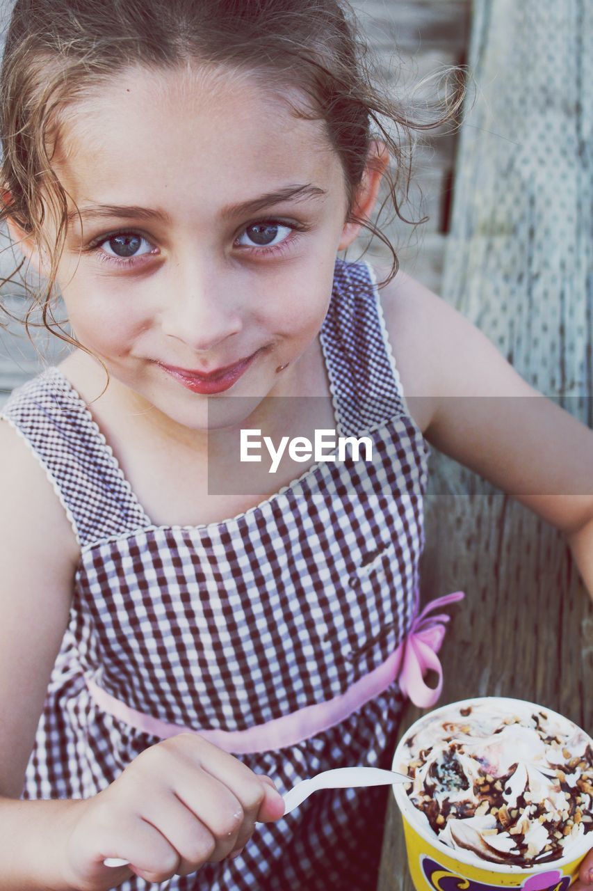 Portrait of smiling girl eating ice cream