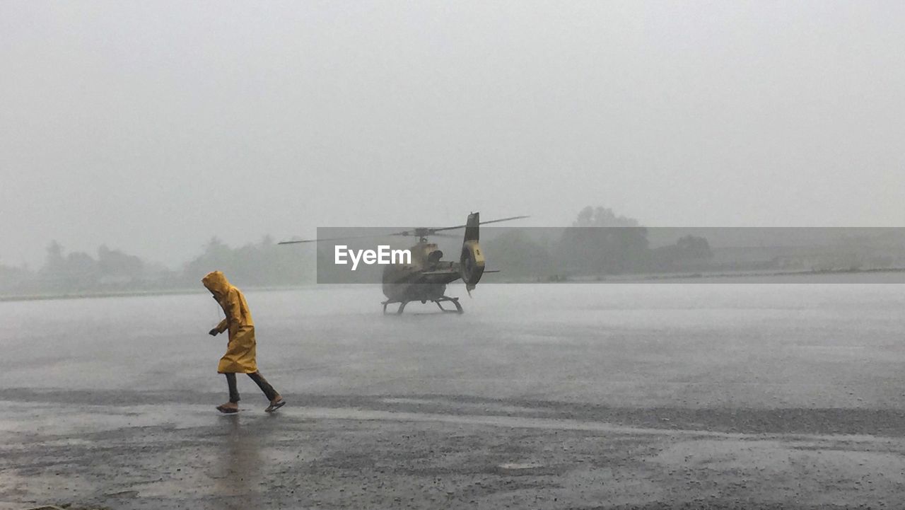 Airport worker running in the rain 