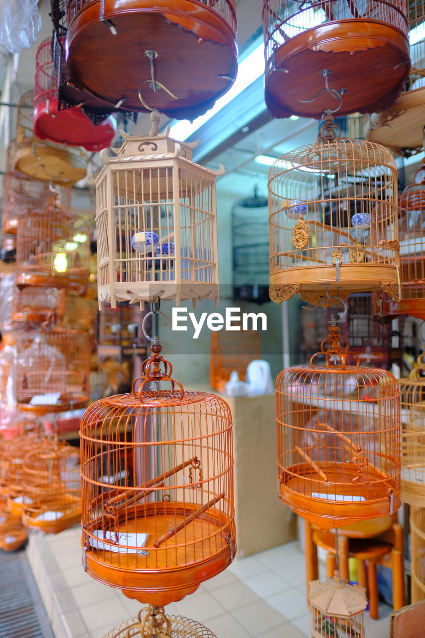 Birdcages hanging in store for sale in market