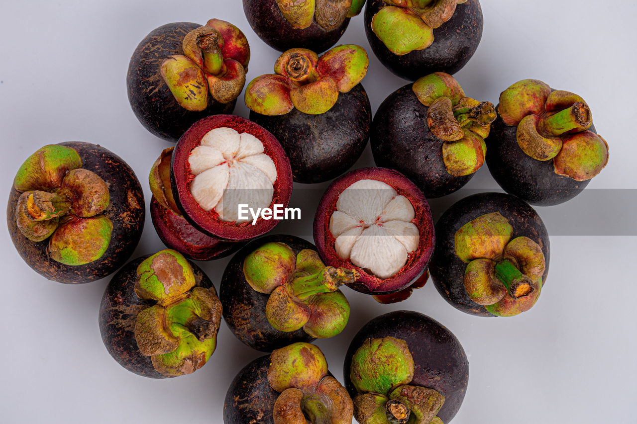 food and drink, food, healthy eating, fruit, freshness, plant, produce, wellbeing, no people, studio shot, still life, indoors, variation, high angle view, directly above, flower, large group of objects, kiwi