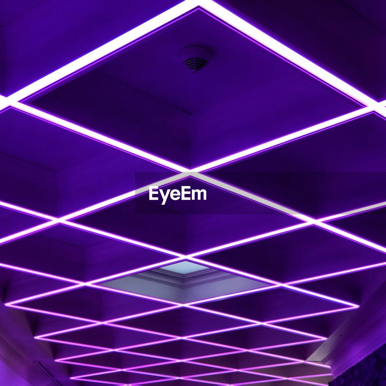 Low angle view of illuminated ceiling lights