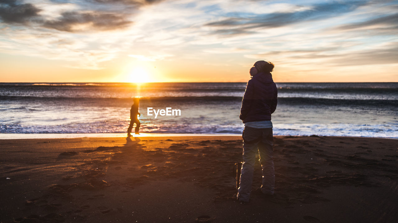 SCENIC VIEW OF BEACH DURING SUNSET