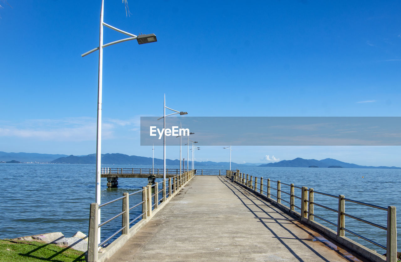 PIER AMIDST SEA AGAINST SKY