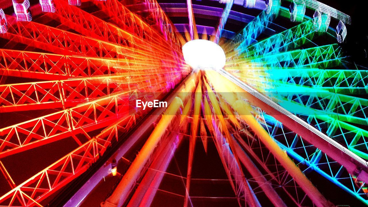 Low angle view of illuminated colorful ferris wheel