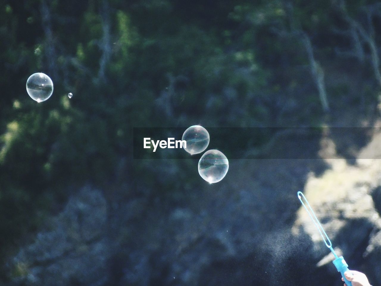 CLOSE-UP OF BUBBLES AGAINST MOON IN SKY